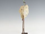 a sculpture of a bird sitting on top of a rock