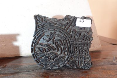 a small decorative object on a table with a price tag