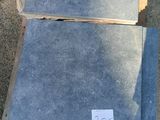 two pieces of concrete sitting on the ground next to each other