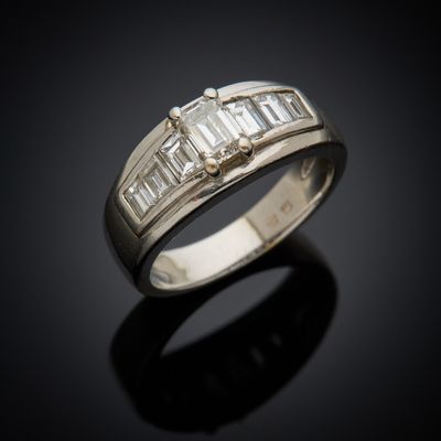 a close up of a diamond ring on a black surface