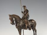 bronze statue of a man on a horse with a sword