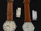 two watches sitting next to each other on a table