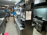 a large kitchen with a lot of stainless steel counter tops