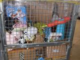 a shopping cart full of stuffed animals in a warehouse