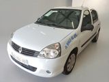 a small white car that is parked in a room