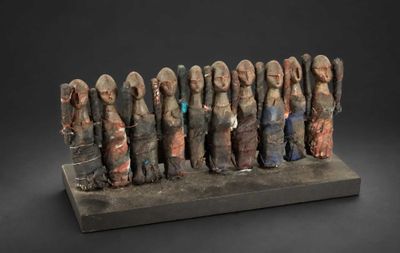 a sculpture of a group of people standing next to each other