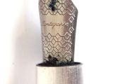 a silver pen with a black tip sitting on top of it
