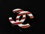 a close up of a red and white chanel logo on a black background