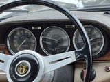 steering wheel and dashboard of a car with a clock and gauges