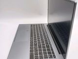 a silver laptop computer sitting on top of a white table