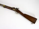 an old rifle with a wooden handle on a white surface