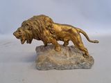 a statue of a lion on a rock on a white surface