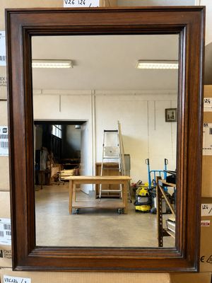 a mirror that is sitting on a table in a room