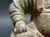 a statue of a man sitting on top of a table