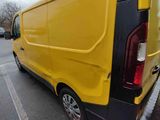 a yellow van that is parked in a parking lot
