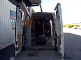 a van that is parked in a lot with its door open