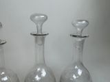 three glass vases that are sitting on a table