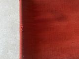 a close up of a red chair on a white floor