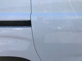 a close up of a car ' s door handle with a sticker on it