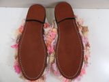 pair of women ' s shoes on a white surface with pink flowers
