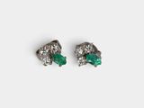 a pair of emerald and diamond earrings on a white background