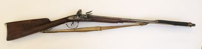 un pistolet et un fusil accrochés l'un à côté de l'autre sur un mur