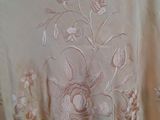a dress with a floral design on it on a mannequin