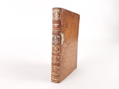 an old book sitting on top of a wooden table