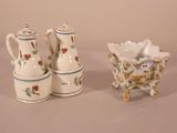 three pieces of pottery sitting on a table