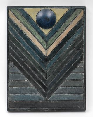 a close up of a piece of art with a blue ball on it