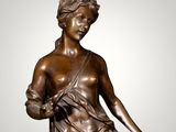 bronze statue of a woman sitting on a marble pedestal
