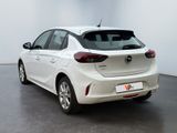 the back end of a white car in a white room