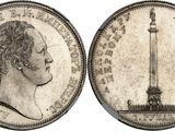 a close up of a coin with a statue in the background