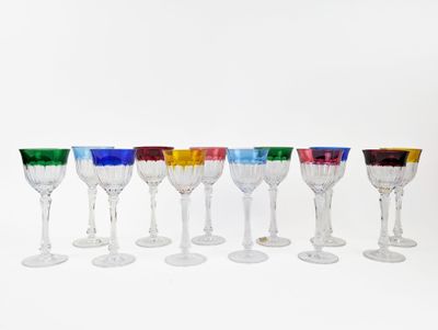 several different colored wine glasses are lined up in a row