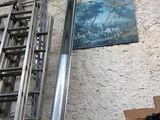 a metal ladder leaning against a wall next to a box of boxes