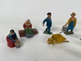 several toy figurines of people in various outfits and hats