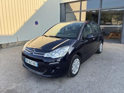 une citrole noire garée devant un immeuble