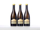 three bottles of wine sitting next to each other on a table