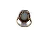 a close up of a ring on a white surface with a white background
