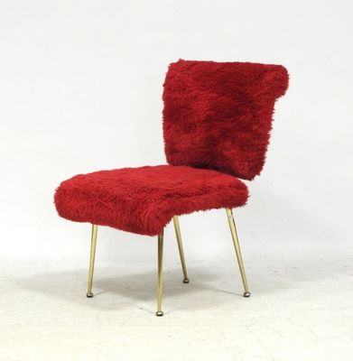 an image of a red chair with gold legs