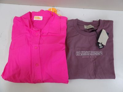 two shirts with a tag on them are sitting on a table