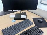 a keyboard, mouse, mouse pad and monitor on a desk