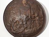 a bronze plaque with a picture of a man and a woman on it