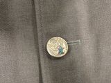 a close up of a button on a suit jacket