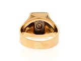 an image of a gold ring with a black stone in it