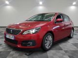 a red car is parked in a room with a checkered floor