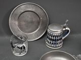 a silver plate and a silver plate with a black and white design on it