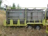 a truck with a trailer attached to it that has a large container on the back of it