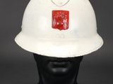 an old white fireman ' s helmet on a black mannequin head