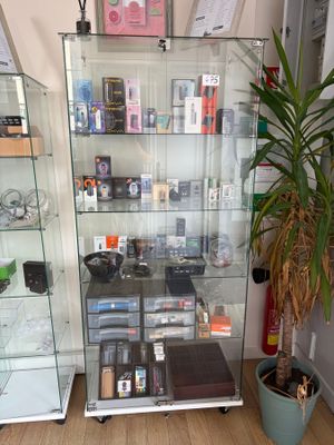 a glass display case with a lot of cell phones in it
